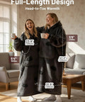 Two women wearing full-length wearable blanket hoodies for adults with flannel and sherpa lining, enjoying coffee at home.