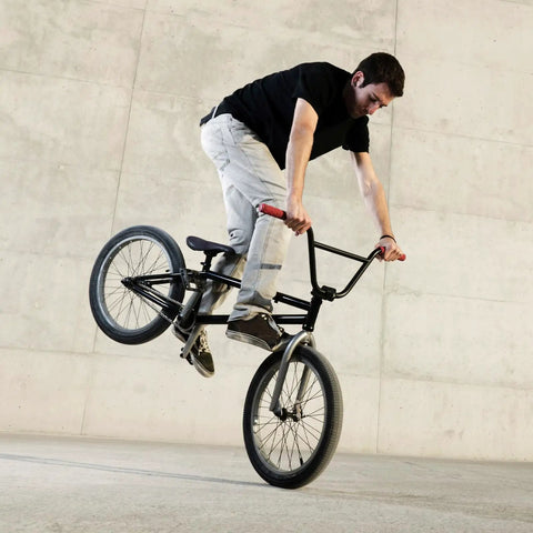 BMX rider performing a trick, showcasing durability of 20 Inch Bike Inner Tube Fits 2.125 To 2.40 Inch Width Tires With Schrader Valve