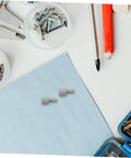Four Pack Motor Adapter Wheel Connectors for Cross Shaft Coupling on light blue surface with tools and screws visible