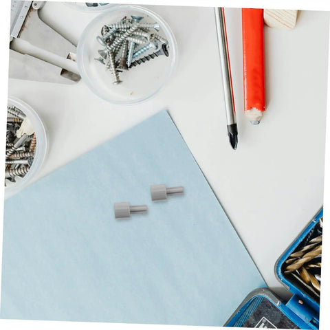 Four Pack Motor Adapter Wheel Connectors for Cross Shaft Coupling on light blue surface with tools and screws visible
