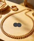 Round Graphite Electrode Plates For Melting And Electrolysis High Purity Graphite Disk Ingots on wooden table with jewelry