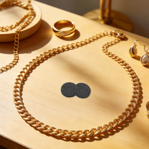 Round Graphite Electrode Plates For Melting And Electrolysis High Purity Graphite Disk Ingots on wooden table with jewelry