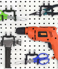 Heavy Duty Pegboard Hooks And Drill Holder Set For Tool Organization 4 Pack Peg Board Hangers holding tools on white pegboard