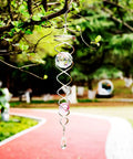 12 Inch Gazing Ball Spiral Tail Dope Wind Spinner With Stainless Steel Construction Two Crystal Glass Prism Balls Hanging Swivel Hook Weatherproof Outdoor Yard Garden Decor Purple hanging from a tree
