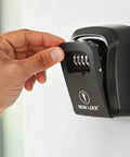 Hand opening the Heavy-Duty Key Lock Box Wall Mount with 4-Digit Combination, Waterproof Metal Safe for Outdoor Access.
