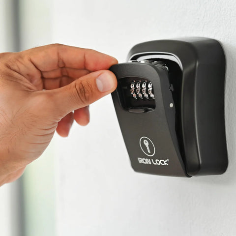 Hand opening the Heavy-Duty Key Lock Box Wall Mount with 4-Digit Combination, Waterproof Metal Safe for Outdoor Access.