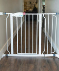 White gate with 6 Inch Gate Extension Guard For Child And Pet Gates That Adds 3 Inches Per Side Extends Pressure Mounted Gates Protects Walls And Baseboards Stabilizes Gate On Stairs Easy Install For Busy Homes installed in hallway