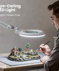 Person using XL Bifocal LED Magnifying Lamp With 7 Inch Acrylic Lens 2.25x And 6x Magnification, 1600 Lumens Dimmable for crafting model