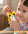 Child holding a handmade felt kitten from Cat Sewing Kit For Kids Beginners Starter Kit With Pre-Punched Felt Learn To Sew For Ages 6 To 12.