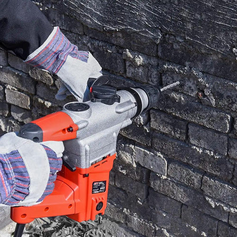 Person using Beast Mode Heavy Duty 1 Inch SDS Plus Rotary Hammer Drill Kit for drilling brick wall. Visible motor and drill bit.
