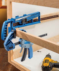 Universal Drawer Slide Jig For Cabinets Easy Install Drawer Slides Quickly And Accurately With A Locking Wedge Adjustable Indexing Foot And Large Clamping Area For Pro Grade Cabinet Hardware Installations with blue tool clamping on wooden cabinet frame.