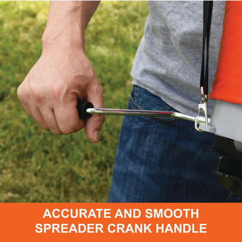 Person using 25 lb handheld bag seeder spreader with waterproof bag and enclosed gears on grass, focusing on crank handle.