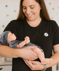 Legit Carefully Sculpted Full Silicone Reborn Boy Doll held by a woman, showcasing flexible joints and soft features.