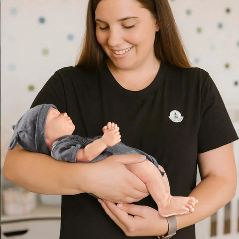 Legit Carefully Sculpted Full Silicone Reborn Boy Doll held by a woman, showcasing flexible joints and soft features.