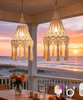 AVAMERY Boho Chic Macrame Pendant Lights with Tassels hanging over a beachside table at sunset with a colorful lamp remote.