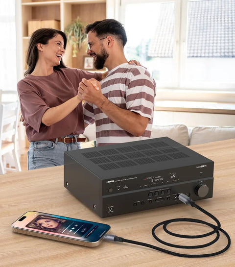 No Hassle Plug And Play Usb C Toslink Optical Audio Cable For Crisp Digital Sound Transfer Across Phones Laptops Smart Tvs And Home Theater Gear With Lossless Stereo Cord Four Feet Long connected from phone to audio receiver in cozy living room.