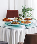 Smooth Operator Tempered Glass Lazy Susan Turntable Serving Tray Hella Sturdy Silent Bearing Rotation For Dining Table Kitchen Centerpiece 70 Cm dinner upgrade with various dishes on it.