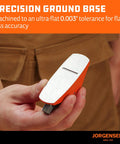 Front view of Jorgensen No.101 mini wood plane with orange body and silver top, held in hand