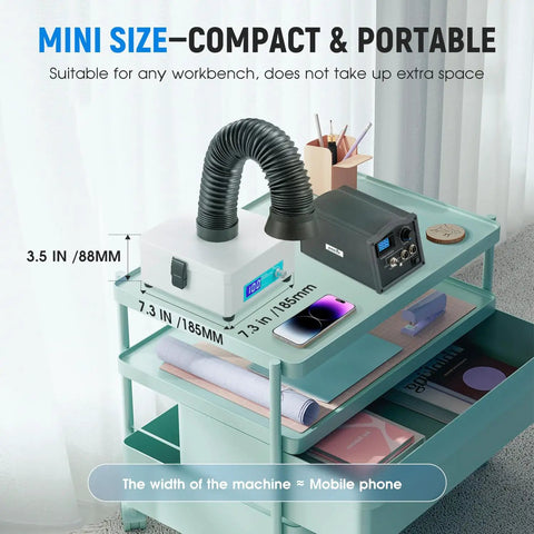 Compact Desktop Solder Fume Extractor With Adjustable Speed And LED Display on a small workbench, size comparison with phone.