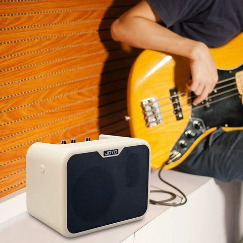 Guitarist using Dope Portable 10W Bass Amp Combo with Dual Channel Mini Bass Amplifier for indoor practice