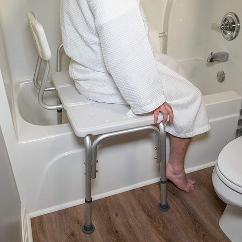 Person sitting on a Tub Transfer Bench With Backrest For Bathtub Height Adjustable Shower Chair Safe Senior Bath Seat Heavy Duty Non Slip Feet Easy In Easy Out For Elderly Care in a bathroom setting.
