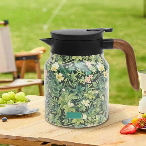 Large Capacity 1000ml Thermal Coffee Carafe And Insulated Tea Pot Stainless Steel Leak-Proof Water Pitcher Keeps Your Brew Hot And Fresh On The Go Green with floral design on a picnic table