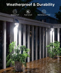 4 Pack Solar Wall Lights Outdoor Stainless Steel Motion Sensor Lamps Waterproof lighting a rainy deck with plants