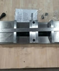 Six Inch Double Lock Cnc Machine Vise With Hardened Steel Bed And Reversible Step Jaws For Heavy Duty Fabrication, top view on wooden surface.