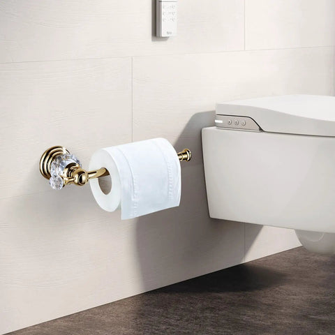 Crystal Gold Toilet Paper Holder for Modern Bathrooms wall mounted next to toilet, showing big roll compatibility and gold finish.