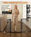 Extra Wide 60 Inch Free Standing Dog Gate For Home Doorways with a woman using the dual-lock system in a modern kitchen.