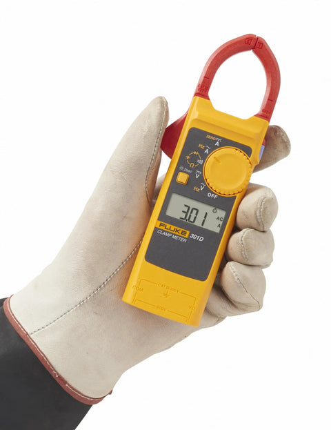 Hand holding a 600 Amp AC DC Clamp Meter With Slim 10 mm Jaw For Tight Space Work, CAT III 300V Safety, Measures Voltage.