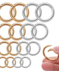 16 Pcs Mini O Ring Clip Spring Carabiner Set For Bags And Purses And Handbags, Round Gold And Silver O Rings And Clasps, Four Sizes For DIY Jewelry Making And Craft Projects. Gold and silver alloy spring O rings in four sizes, one open clip shown in hand.