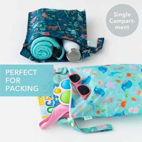Super Handy Waterproof Wet Bag Two Pack For Travel And Beach with colorful prints, filled with accessories, towels, sunglasses.