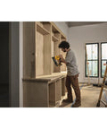 Person using 20V Cordless Angled 16 Gauge Finish Nailer Tool Only, Brushless Motor for cabinet installation, no compressor needed.
