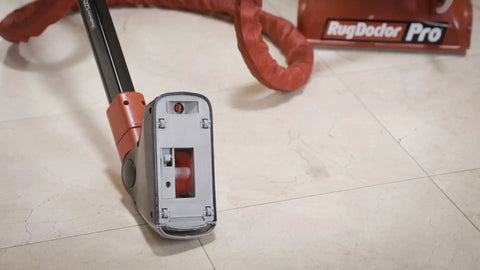 Motorized Grout Cleaning Tool For Deep Carpet Cleaners with attachment showing 1-inch grout line guides on tile floor