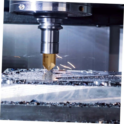 Steel chamfering cutter with hex shank installed in a milling spindle, cutting metal with chips.
