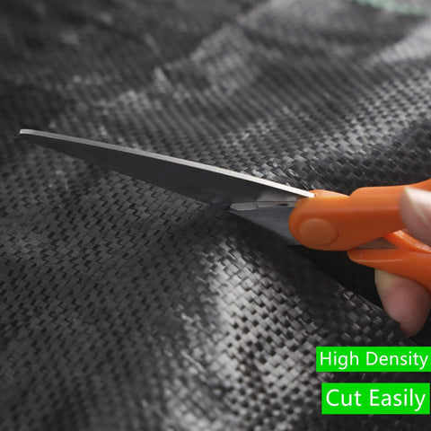 Close-up of scissors cutting Heavy Duty Weed Barrier Fabric 3ft By 300ft 3.2oz Tear-Resistant Ground Cover