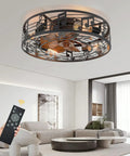 20-inch black caged ceiling fan with lights in a living room, remote control visible, featuring industrial farmhouse design.