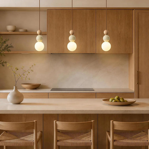 Wabi Sabi Travertine Pendant Light with Wood Ball & Milk Glass Shade above a kitchen island with wooden cabinetry.