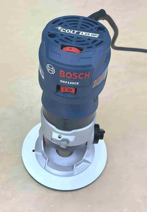 Bosch Colt GKF125CE router featuring the Rock Hard Solid White Phenolic Router Bushing Plate for compact modeling.