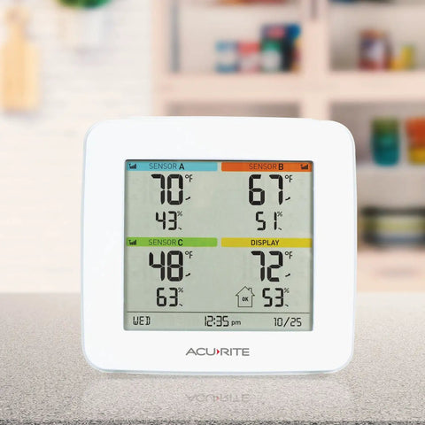 Four Location Home Weather Station With Three Wireless Indoor Outdoor Sensors And Built In Display For Real Time Temperature And Humidity Readings Across Indoor And Outdoor Spaces on a countertop