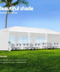 10 By 30 Outdoor Party Tent For Weddings And Events With Heavy Duty Canopy Water Resistant And UV Protected Includes Five Removable Sidewalls Ideal Garden Patio Backyard Gazebo White shown on grass with tables and chairs inside.