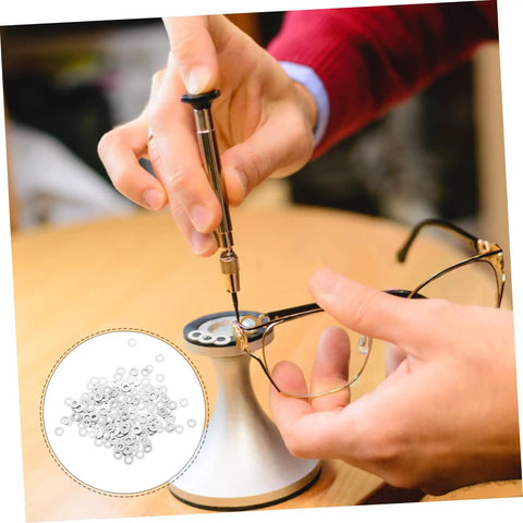 Person using screwdriver to repair rimless eyewear with Eyeglass Screw Gaskets And Metal Washers For Rimless Frames Durable Eyewear Fix Kit