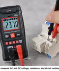 Person using 4000 Count Digital Multimeter with Backlit Display Auto Range Handheld Tester for AC and DC voltage measurement.