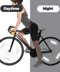 Cyclist with bike showing 4 Pack Bike Spoke Reflectors For Night Riding Safety High Visibility Wheel Reflectors for day and night use.