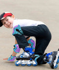 Child wearing Kickin Safe Kids Protective Gear Set Knee Pads Elbow Pads Wrist Guards for Roller Skating on pavement