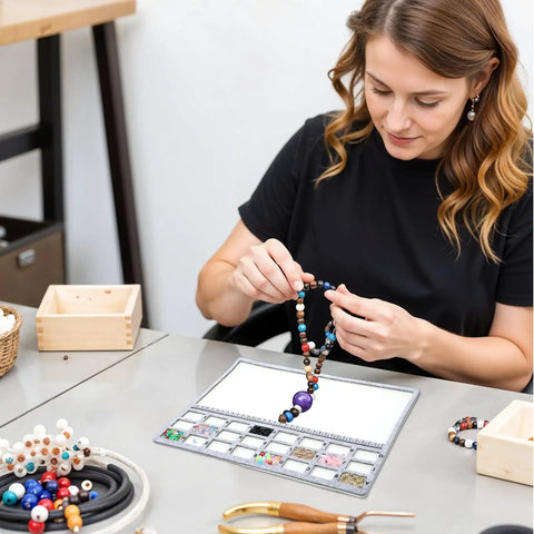Woman arranging beads on a Solid Felt Beading Mat Featuring Sweet Non Slip Flocking Independent Grids 14 X 11 Inch.