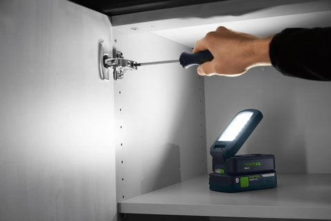 Person using screwdriver by Go Anywhere Cordless Task Light SYSLITE KAL C Go-To Handy Work Light inside cabinet