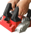 Heavy Duty 1300W Electric Wall Paint Scraper For No Sweat Putty Removal And Concrete Surface Prepping Featuring Pro Grade Multi Blade Handheld Wall Planer with ergonomic handles being held.
