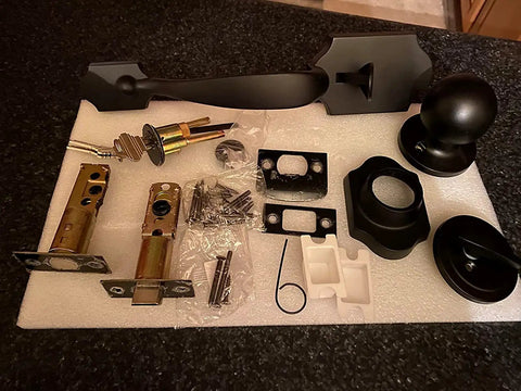 Black Front Door Knob And Deadbolt Set With Reversible Handle Traditional Single Cylinder Exterior Door Lock For Left Or Right Handed Doors Heavy Duty Metal Construction Easy Install layed out on foam sheet.
